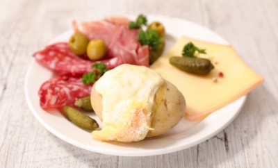 poato with raclette cheese melted, salami and bacon