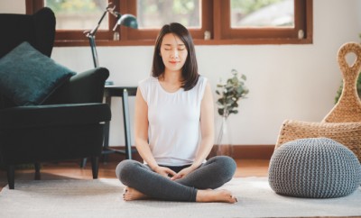 Happy Asian woman sporty attractive practicing meditation at home in living room