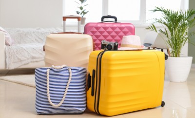 Packed suitcases and beach bag in room. Travel concept