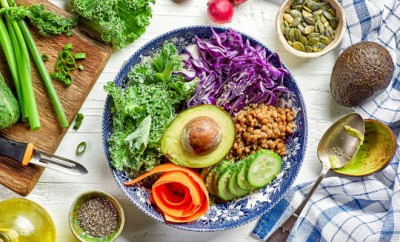 Breakfast power bowl on white wooden table, top view