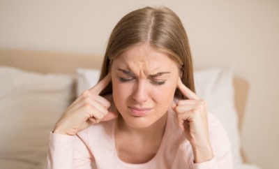 Angry woman disturbed with a noise having problems with sleeping