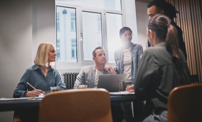 Diverse group of businesspeople working together around a boardroom table during an office meeting