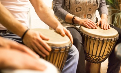 Close up of hands on african drums, drumming for a music therapy