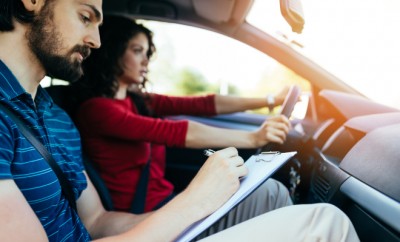 Driving school or test. Beautiful young woman learning how to dr