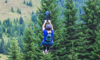 Descent from the mountain on a metal cable. Zipline is an extreme kind of fun in nature