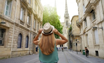 Tourism in France. Back view of traveler girl visiting the city of Bordeaux, France.