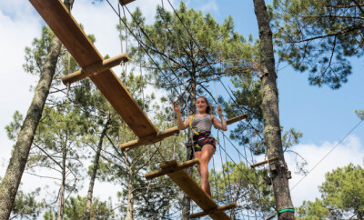 pretty young woman in an extreme tree climbing course