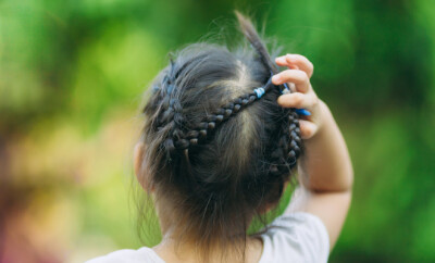 A girl scratch on her hair. The head lice makes itself at home on the kids hair.This annoying parasite can cause itching and other mild symptoms.